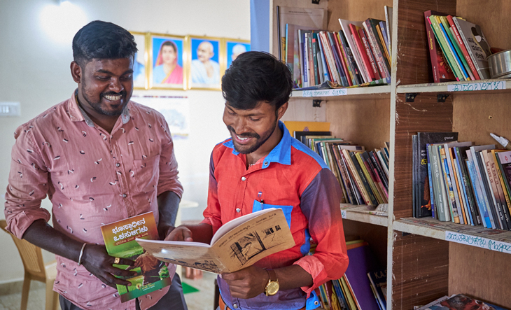 Library with books about women's rights, two men are reading books 